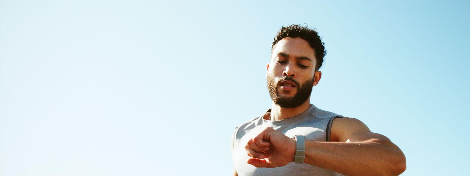 Man running looking at smart watch