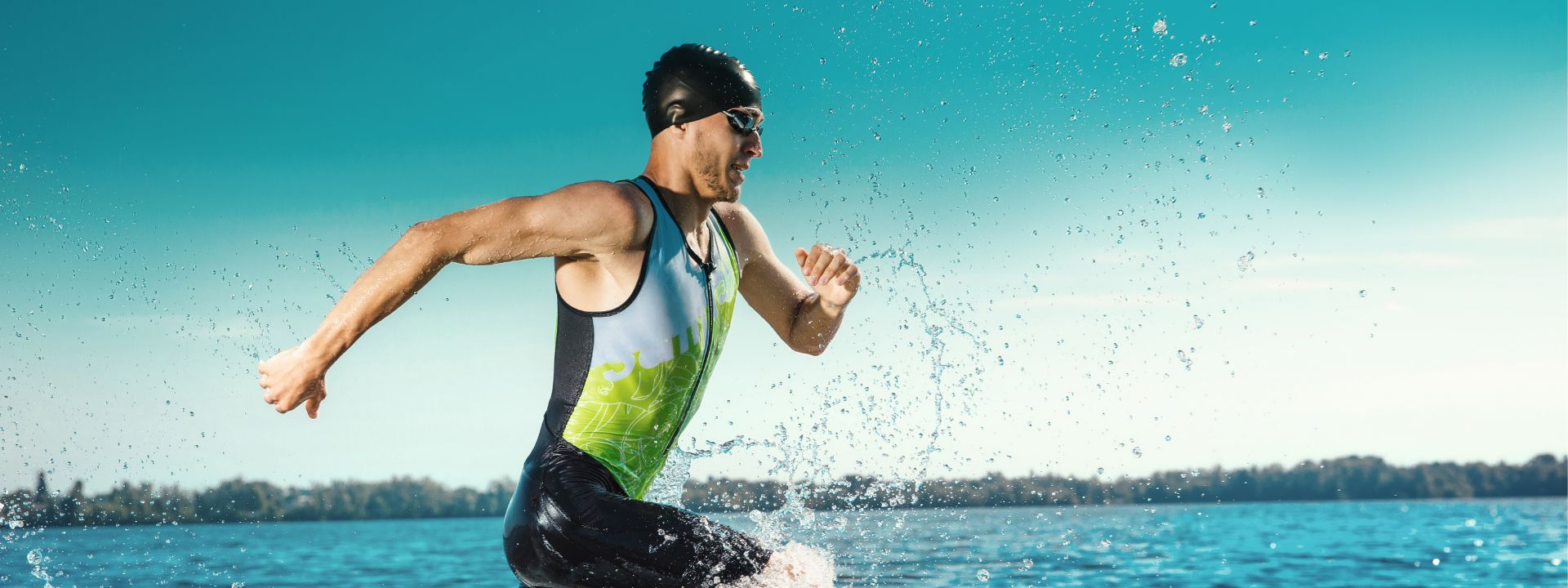 Triathlete running into the water