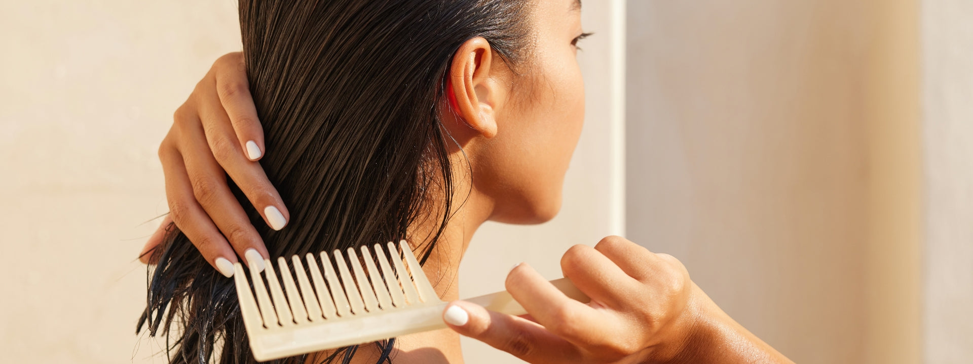 Woman brushing wet hair